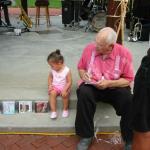 Franz Signing Autographs with Grandaughter Jade Observing